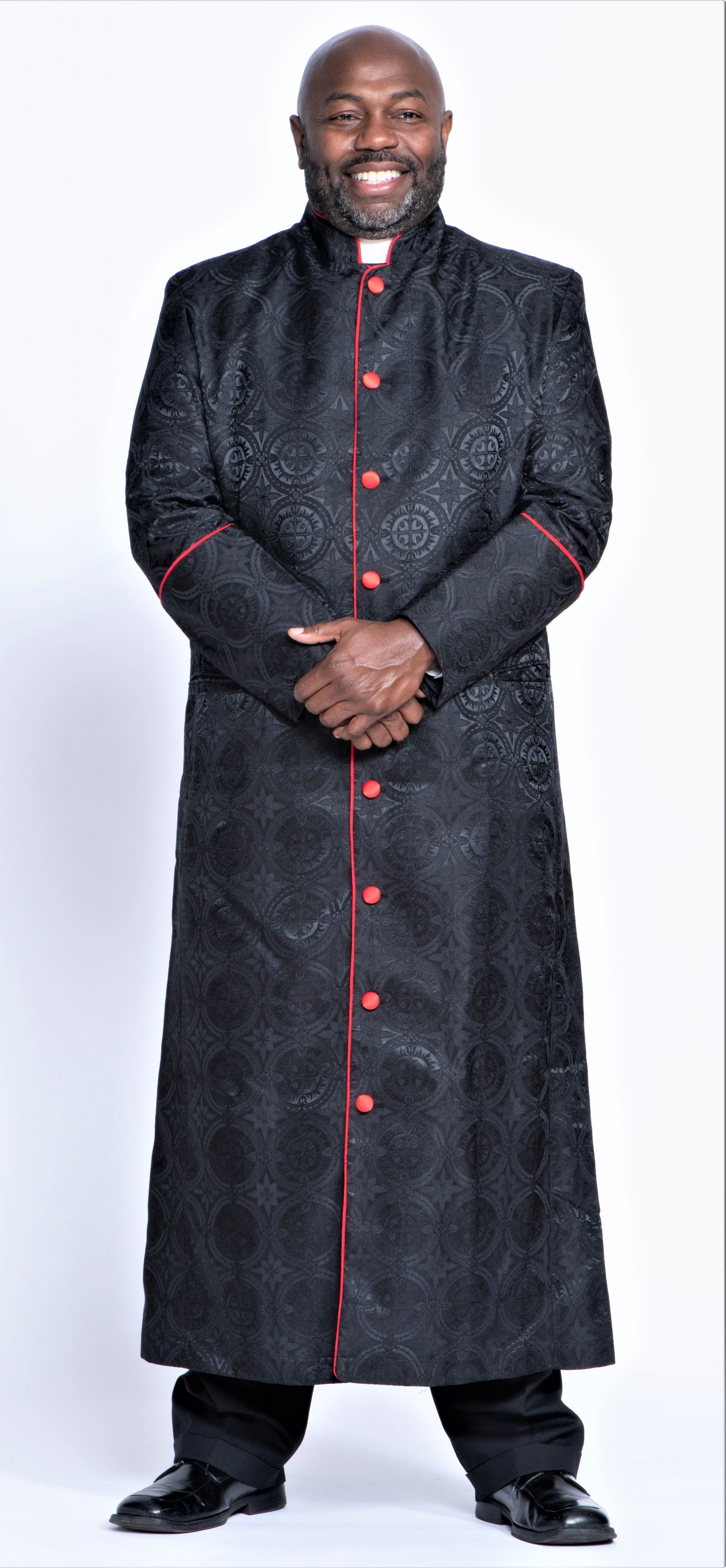 Men's Clergy Robes & Robe Sets - A man wearing a stylish black clergy robe with red accents, showcasing traditional church attire.