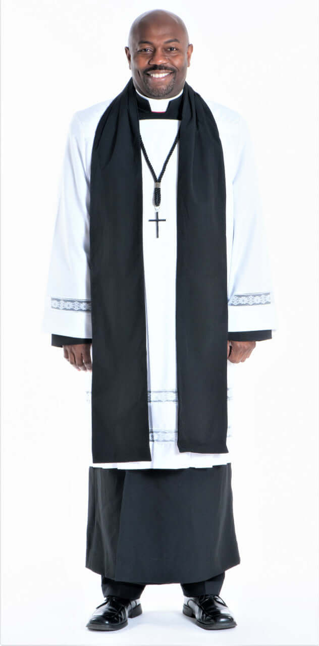 Men's Class A Vestment - 6 Piece Complete Set worn by a smiling man in clergy attire with a black scarf and pectoral cross.