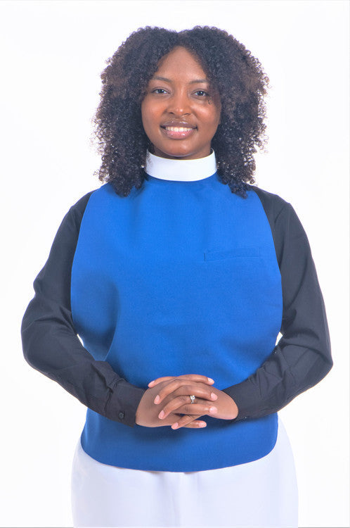 Woman in blue Women's Overseer Attire with a black shirt and smiling expression.