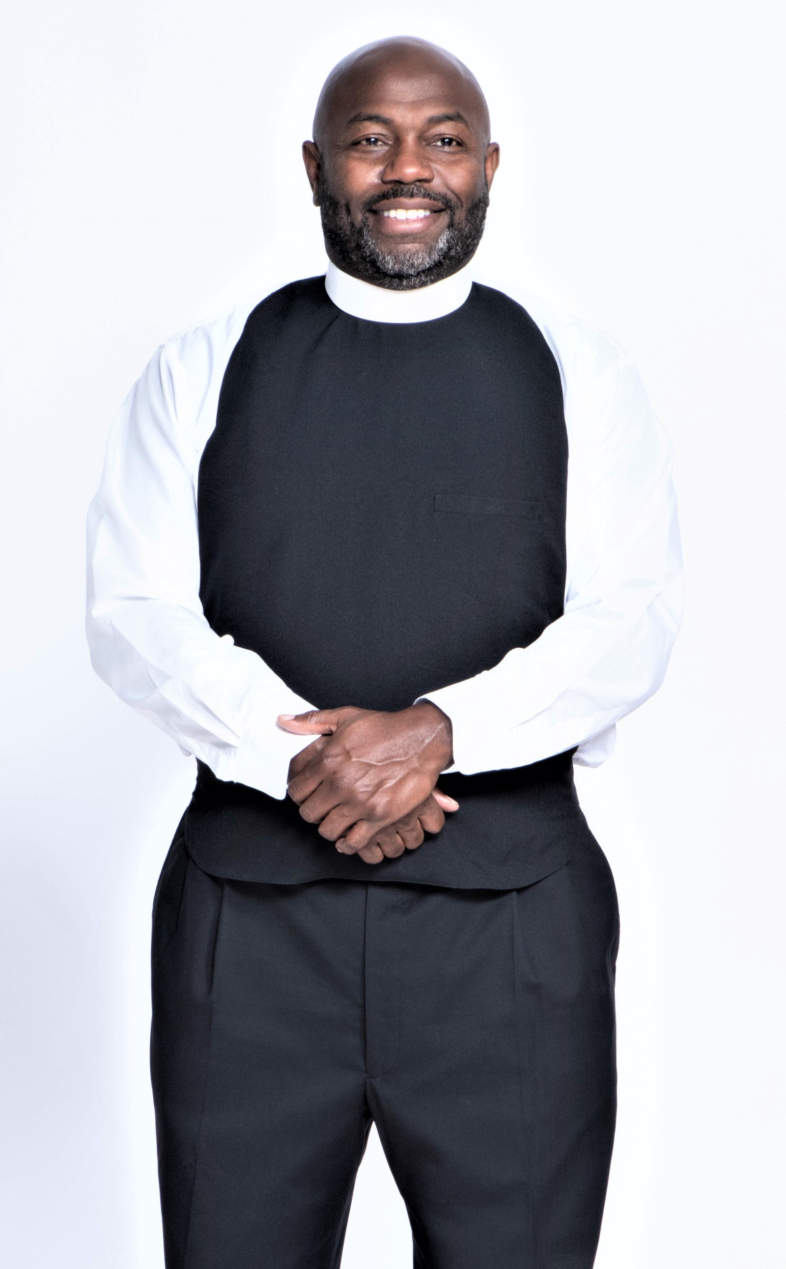 Men's Clergy Rabats - clergy attire featuring a black vestment and white shirt on a smiling man.