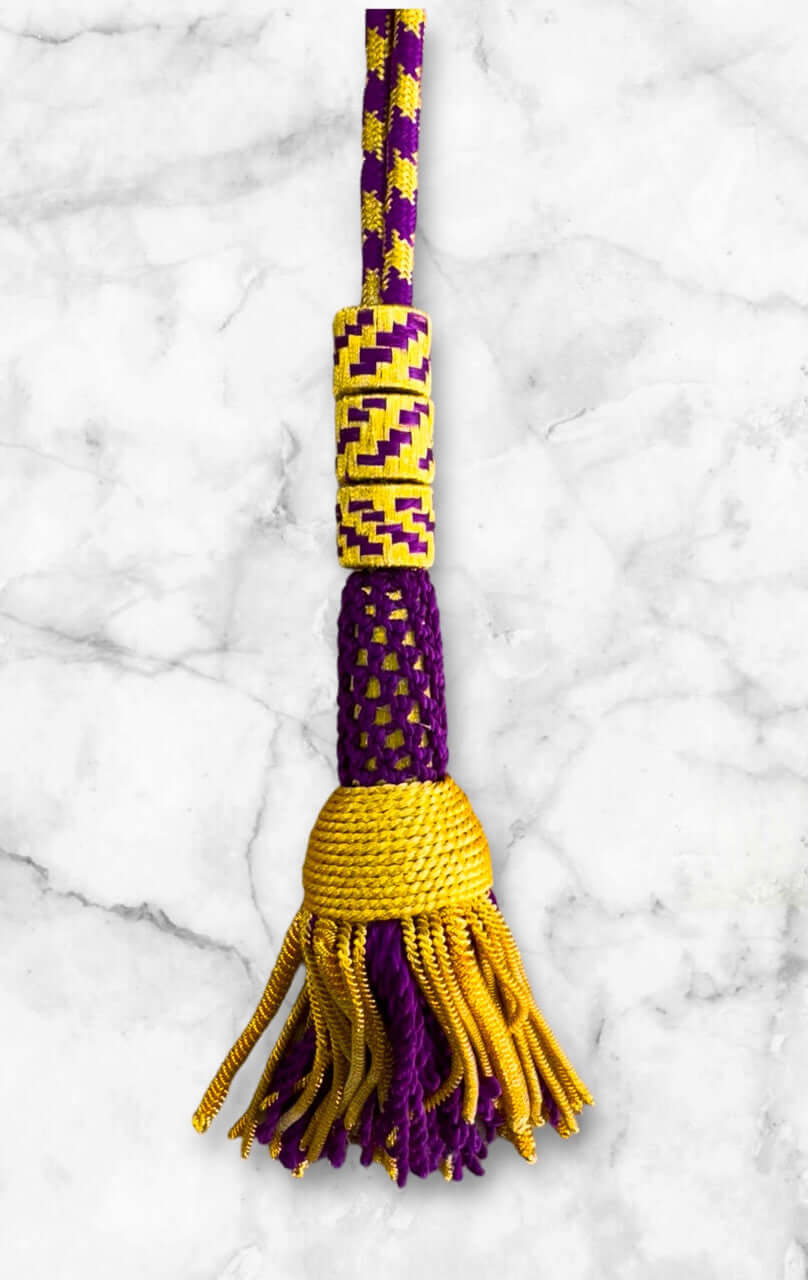 Ceremonial Cord in Purple & Gold featuring a vibrant tassel and unique design for pectoral cross attachment.