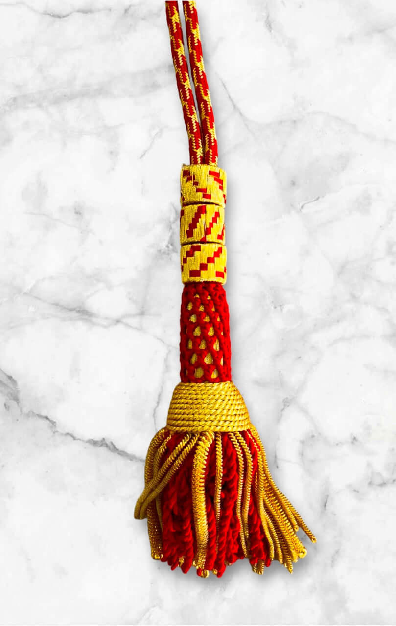 Ceremonial Cord in Red & Gold featuring vibrant tassel and intricate design.