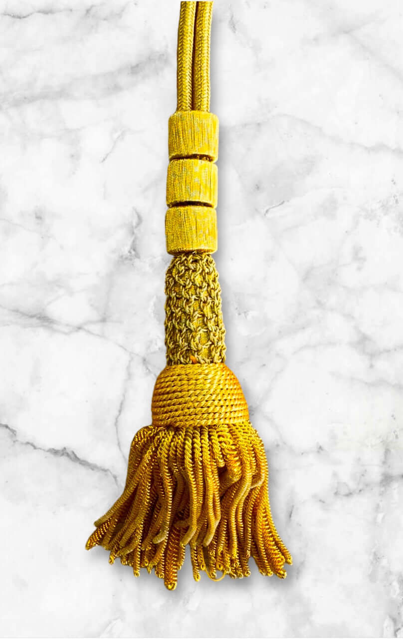 Ceremonial Cord in Gold with intricate tassel design and vibrant hook detail.
