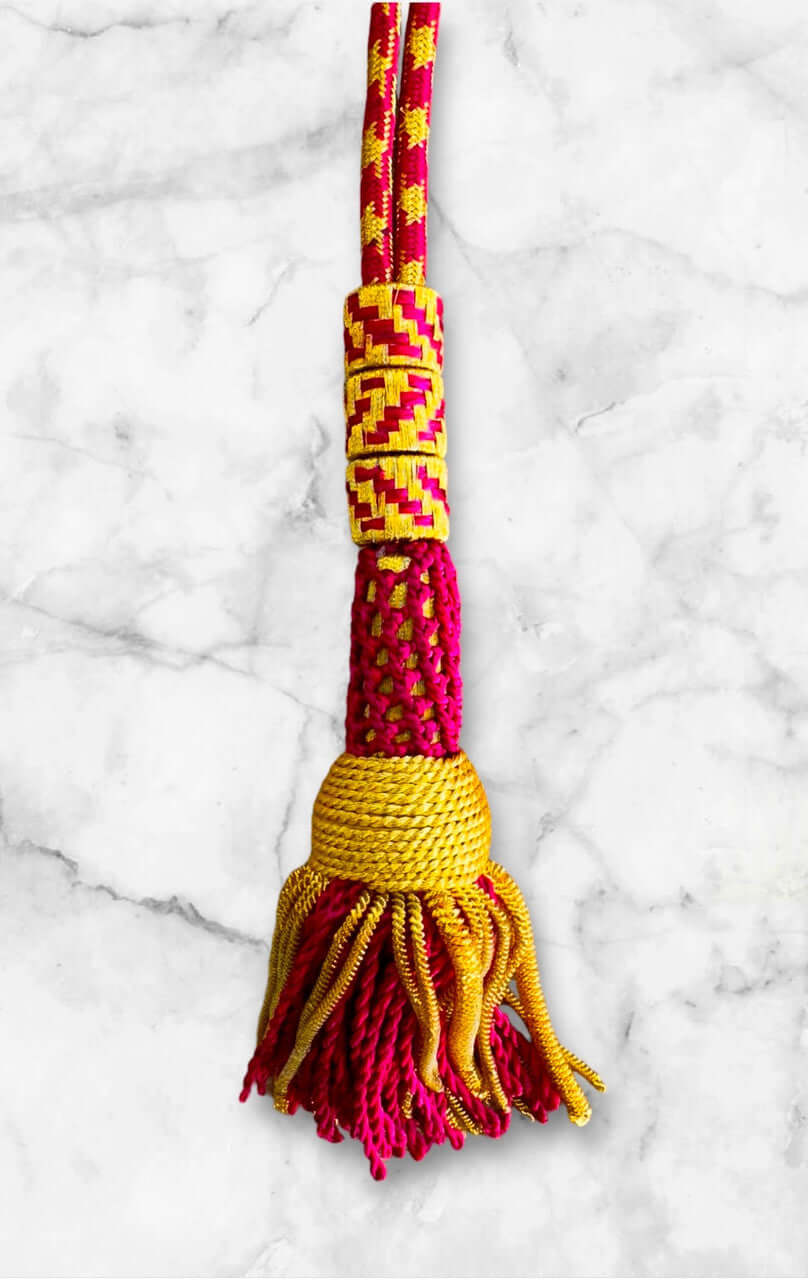 Ceremonial Cord in Fuchsia & Gold: vibrant tassel with intricate design and colors, ideal for pectoral cross attachment.