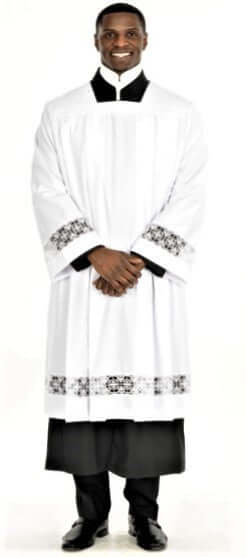 Surplice With Liturgical Cross Lace worn by a man, showcasing fine lace detail, deep pleated body, and polished tailored look.
